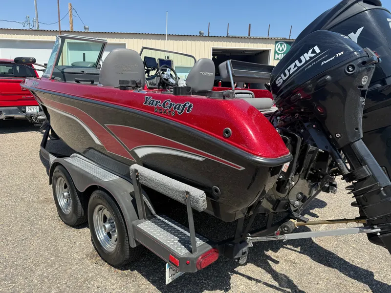 Slide: The Image of 2016 Yar-Craft 209TFX boat with Suzuki motor on trailer, parked outdoors. - 5