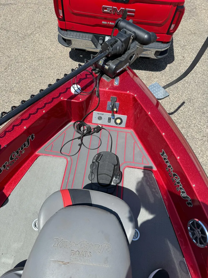 Slide: The Image of 2016 Yar-Craft 209TFX boat with red detailing, parked behind a red GMC truck. - 9