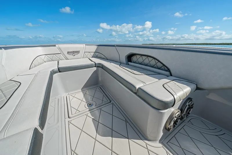 Slide: The Image of 2025 Deep Impact 369 Sport boat interior with luxurious seating and ocean view. - 13