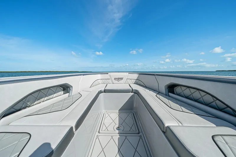 Slide: The Image of 2025 Deep Impact 369 Sport boat interior with luxurious seating and ocean view. - 14