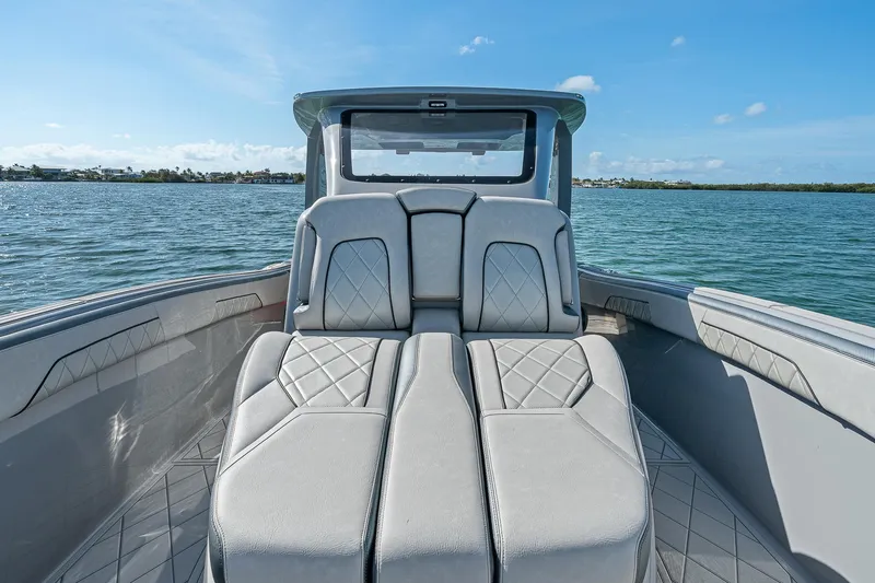 Slide: The Image of 2025 Deep Impact 369 Sport boat interior with luxurious seating on calm water. - 16