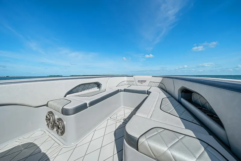 Slide: The Image of Luxury seating on 2025 Deep Impact 369 Sport boat under clear blue sky. - 17