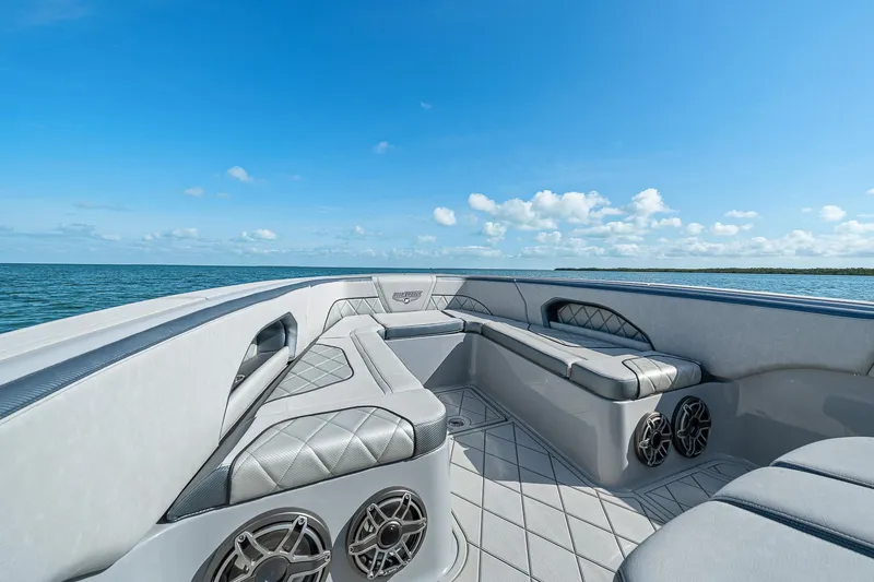 Slide: The Image of Luxury seating on 2025 Deep Impact 369 Sport boat, ocean view, clear sky. - 19