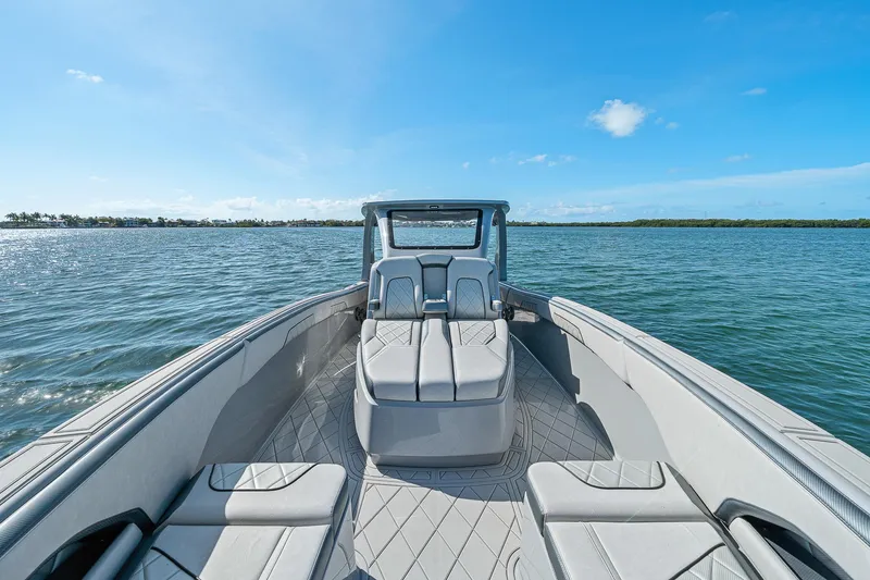 Slide: The Image of 2025 Deep Impact 369 Sport boat on open water under clear blue sky. - 20