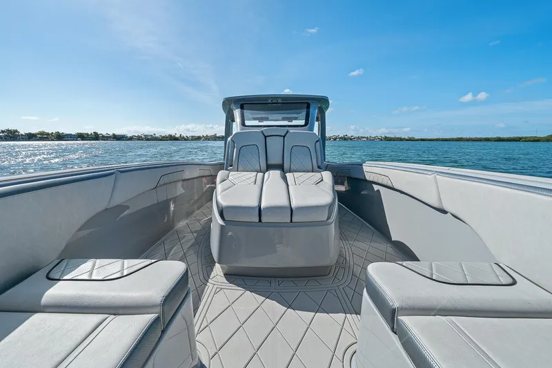 Slide: The Image of 2025 Deep Impact 369 Sport boat interior with luxurious seating on a sunny day. - 21