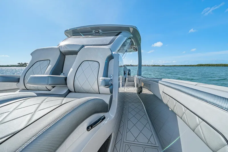 Slide: The Image of 2025 Deep Impact 369 Sport boat interior with luxurious seating on a sunny day. - 22