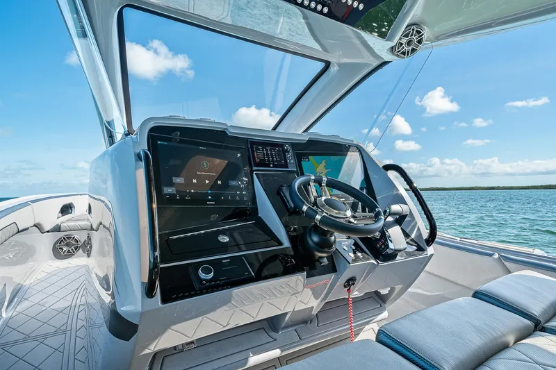 Slide: The Image of 2025 Deep Impact 369 Sport boat cockpit with advanced navigation systems and ocean view. - 24