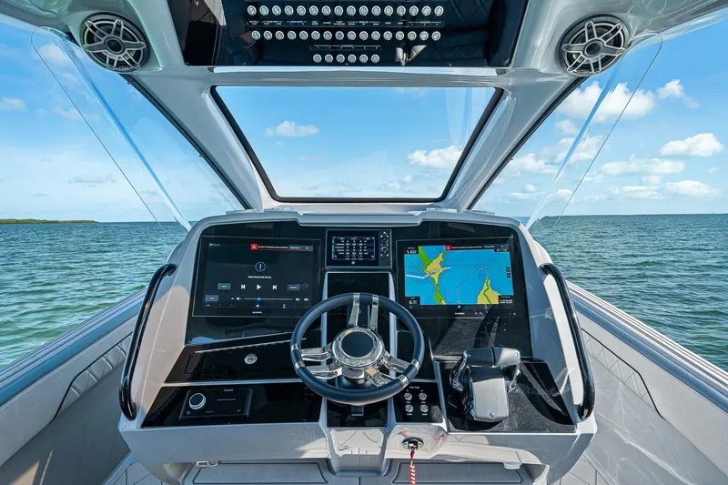 Slide: The Image of Helm of 2025 Deep Impact 369 Sport boat with advanced navigation displays. - 26
