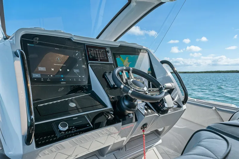 Slide: The Image of Helm of 2025 Deep Impact 369 Sport boat with advanced navigation displays. - 27