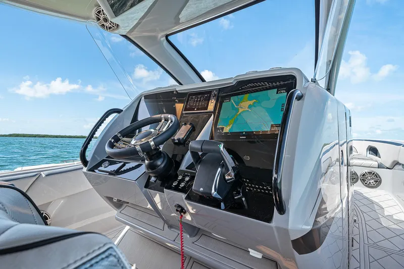 Slide: The Image of 2025 Deep Impact 369 Sport boat cockpit with advanced navigation system and steering wheel. - 29