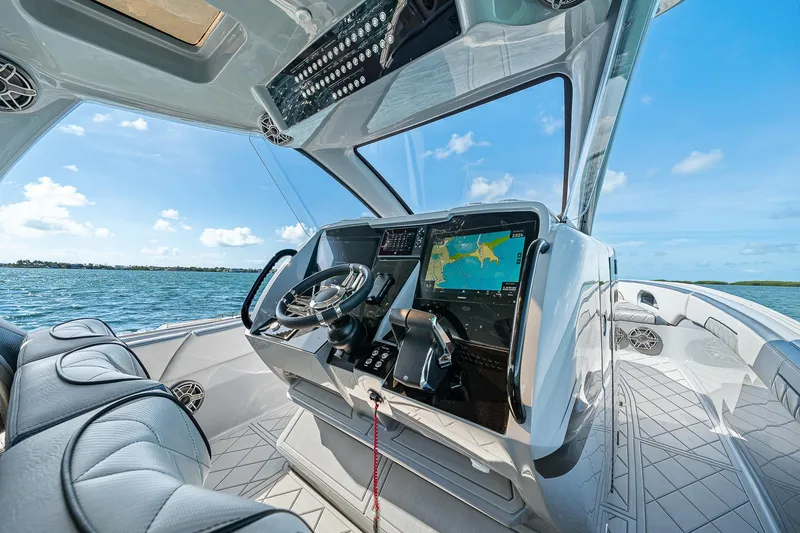 Slide: The Image of 2025 Deep Impact 369 Sport boat cockpit with advanced navigation system on open water. - 30