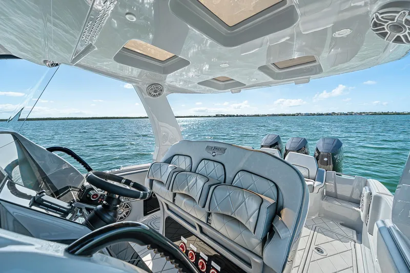 Slide: The Image of 2025 Deep Impact 369 Sport boat interior with luxurious seating and ocean view. - 31