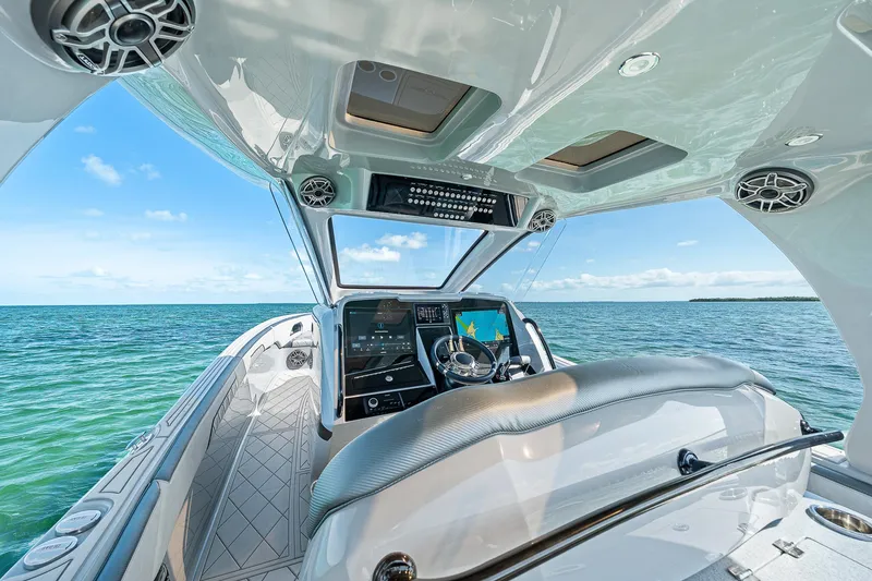 Slide: The Image of 2025 Deep Impact 369 Sport boat interior with ocean view, featuring advanced navigation system. - 32