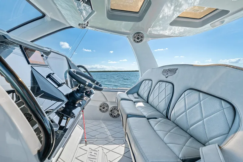 Slide: The Image of Interior of 2025 Deep Impact 369 Sport boat with luxurious seating and modern controls. - 34