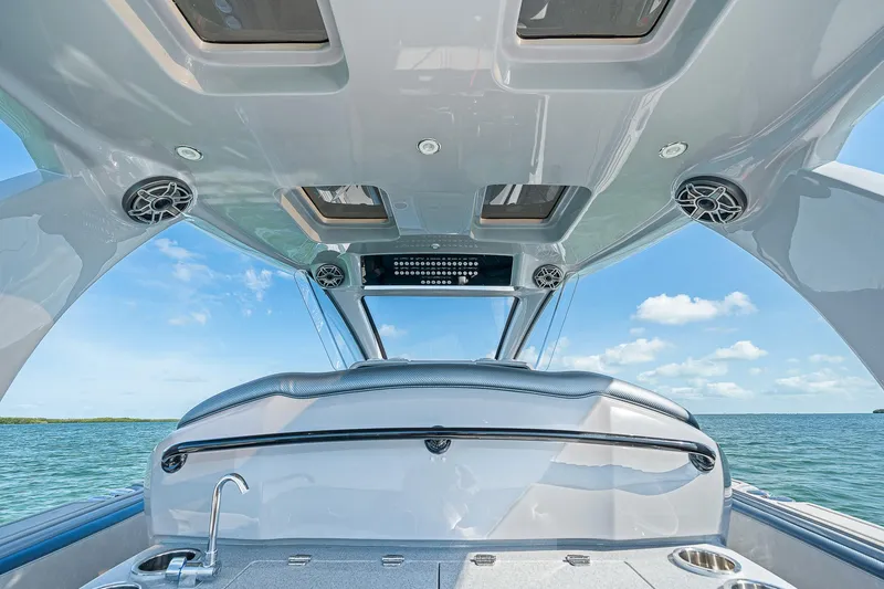 Slide: The Image of 2025 Deep Impact 369 Sport boat interior with speakers and ocean view. - 38