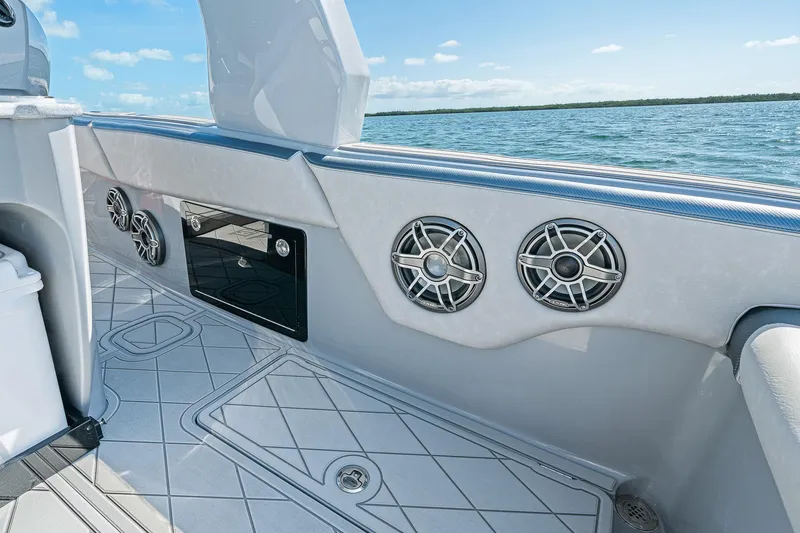 Slide: The Image of 2025 Deep Impact 369 Sport boat interior with speakers, ocean view, and sleek design. - 49