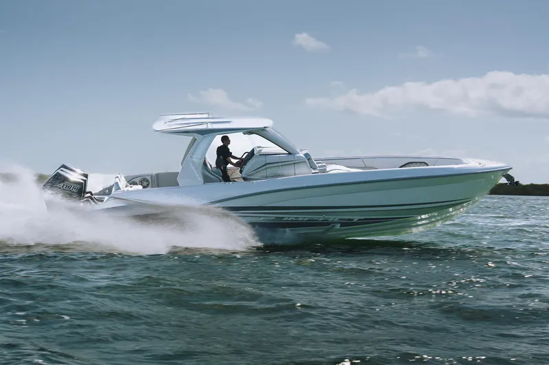 Slide: The Image of 2025 Deep Impact 369 Sport boat speeding on open water under clear skies. - 5