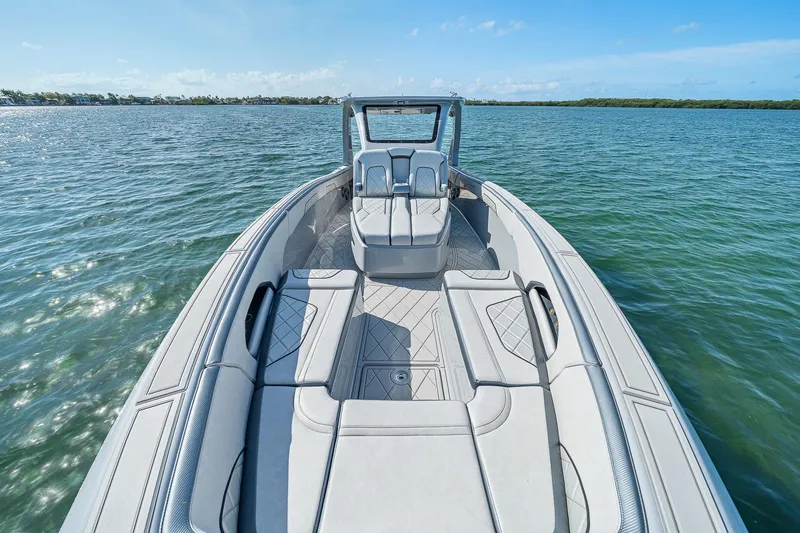Slide: The Image of 2025 Deep Impact 369 Sport boat on calm water, showcasing sleek design and spacious seating. - 8