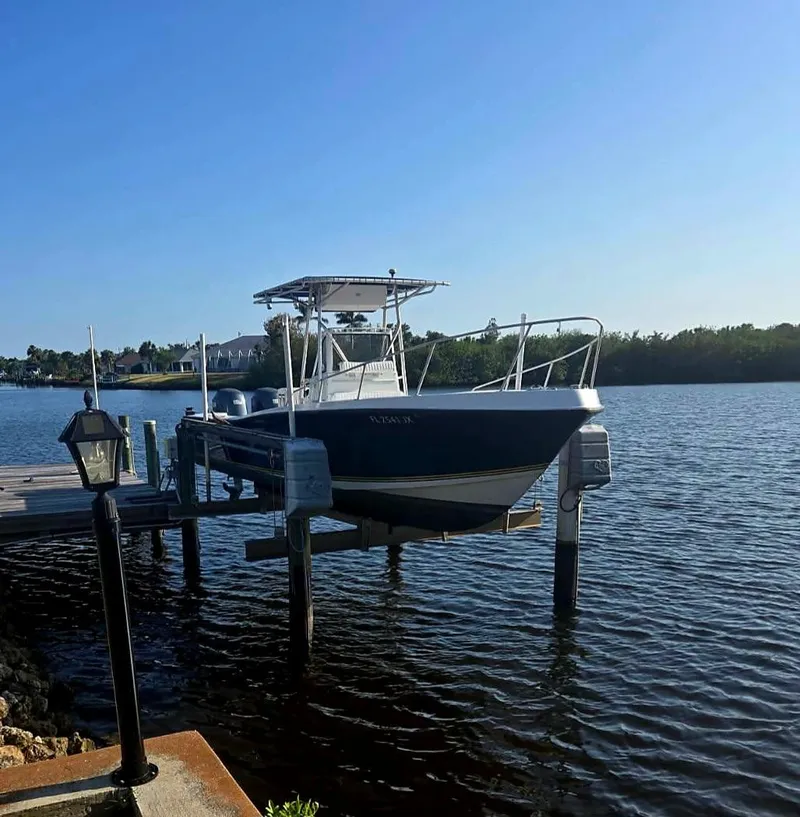 Slide: The Image of 1985 Mako 254 Center Console boat docked on a sunny day. - 3