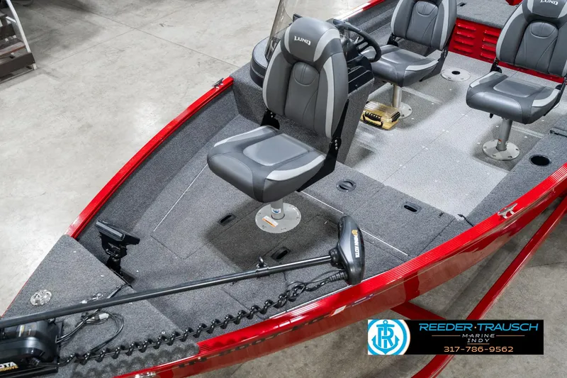 Slide: The Image of 2021 Lund 1650 ANG SS boat interior with gray seats and red exterior. - 10