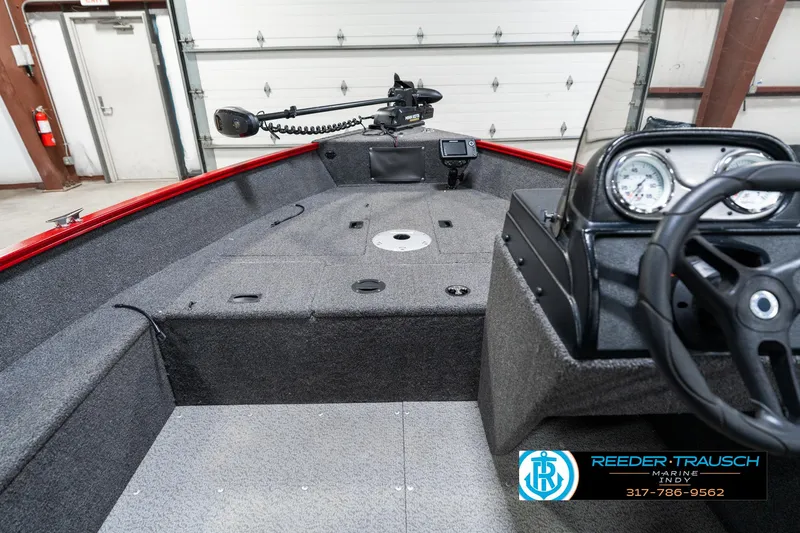 Slide: The Image of 2021 Lund 1650 ANG SS boat interior with steering console and fishing equipment. - 15