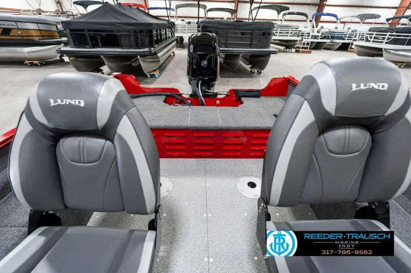 Slide: The Image of 2021 Lund 1650 ANG SS boat interior with two gray seats in a showroom. - 17