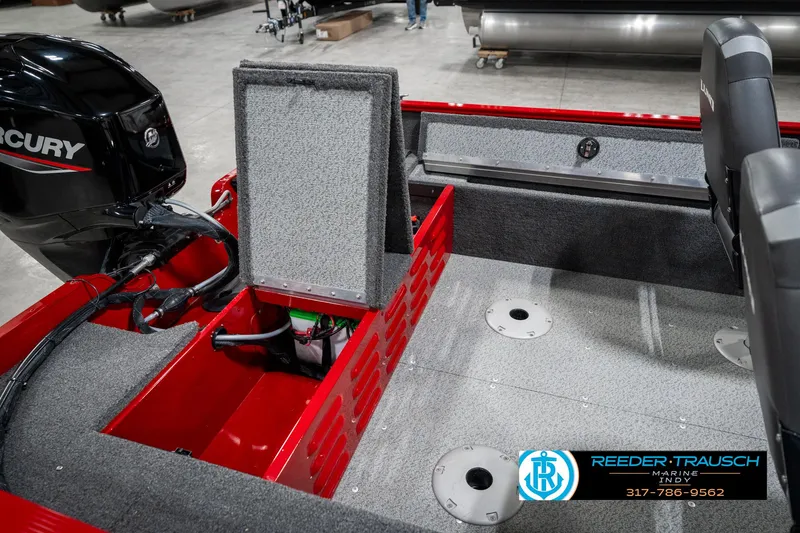Slide: The Image of 2021 Lund 1650 ANG SS boat interior with Mercury engine, featuring storage compartments and seating. - 24