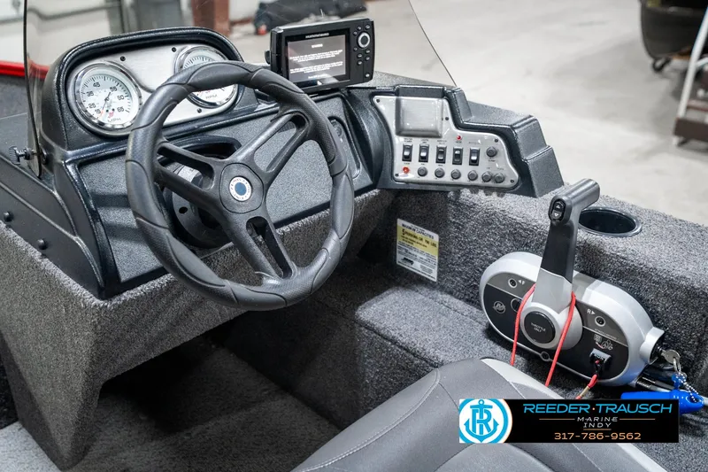 Slide: The Image of 2021 Lund 1650 ANG SS boat dashboard with steering wheel and control panel. - 26