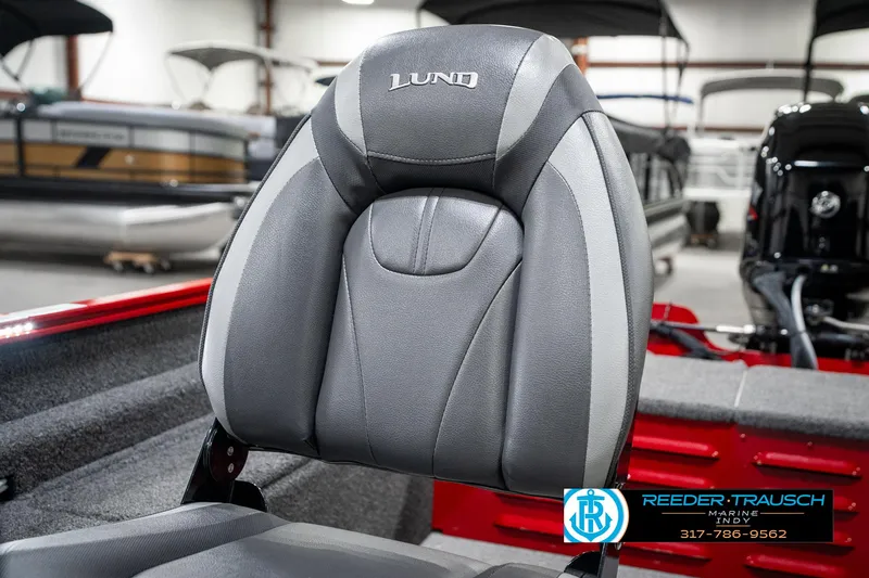 Slide: The Image of 2021 Lund 1650 ANG SS boat seat in showroom, featuring gray upholstery and logo. - 31