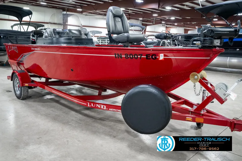 Slide: The Image of 2021 Lund 1650 ANG SS red boat on trailer in indoor showroom. - 4