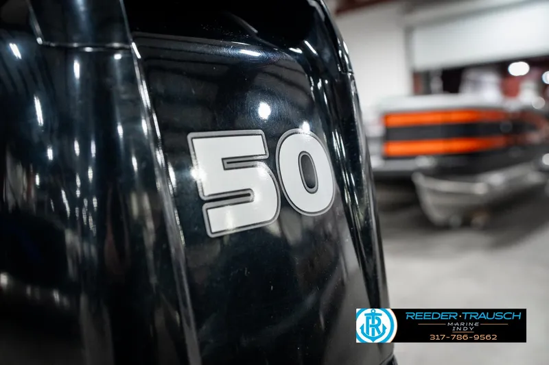 Slide: The Image of 2021 Lund 1650 ANG SS boat engine with "50" marking in a showroom. - 40