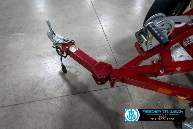 Slide: The Image of Red trailer hitch of a 2021 Lund 1650 ANG SS boat on concrete floor. - 46