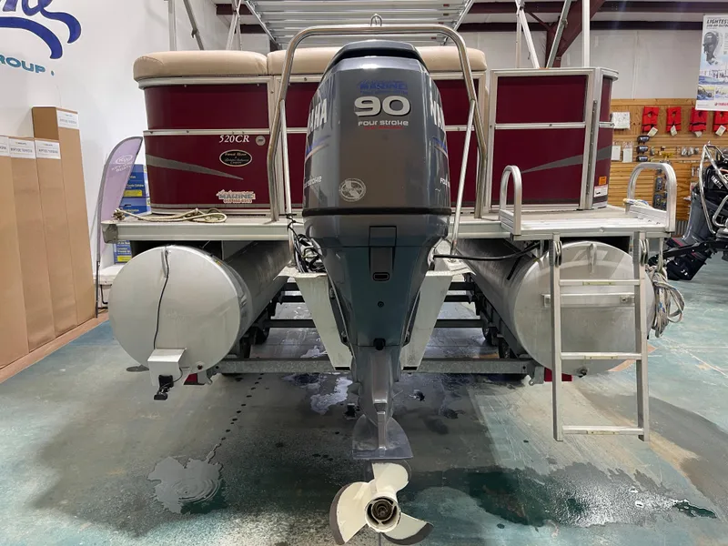 Slide: The Image of 2010 South Bay 520CR pontoon boat with Yamaha 90 horsepower outboard motor in showroom. - 10