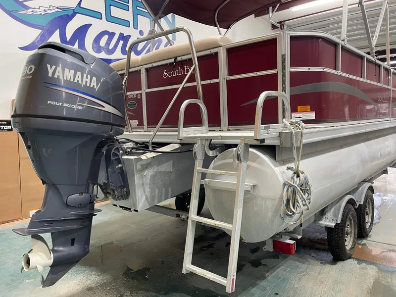 Slide: The Image of 2010 South Bay 520CR pontoon boat with Yamaha outboard motor in a marina. - 11