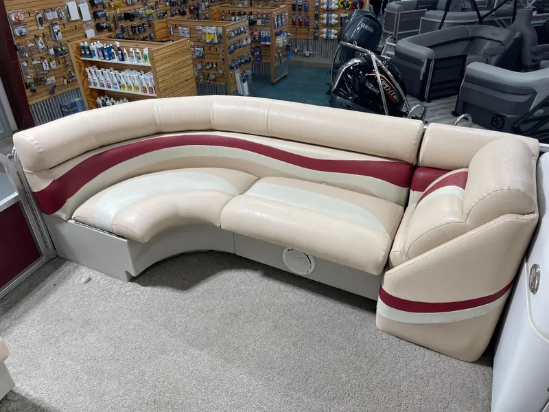 Slide: The Image of 2010 South Bay 520CR boat seating with beige and red upholstery in a showroom. - 13