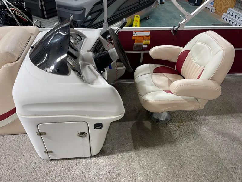 Slide: The Image of Captain's chair and console of a 2010 South Bay 520CR pontoon boat. - 16