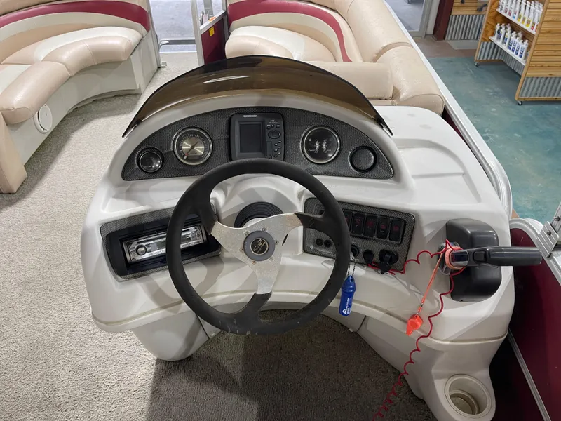 Slide: The Image of Steering console of a 2010 South Bay 520CR pontoon boat with gauges and controls. - 17