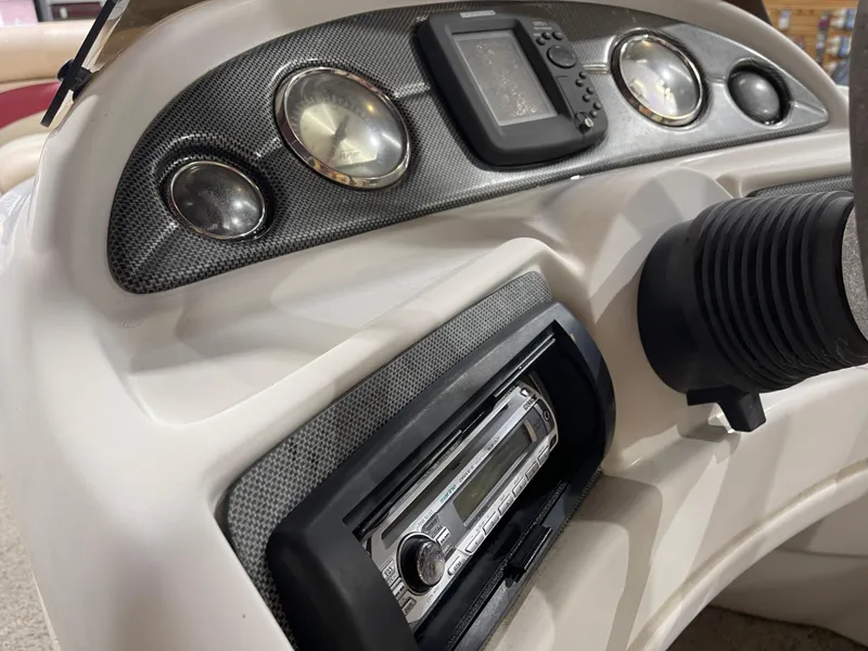 Slide: The Image of Dashboard of a 2010 South Bay 520CR boat with gauges and stereo system. - 18