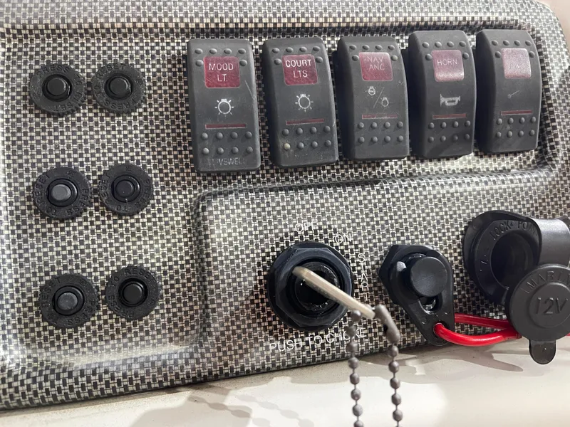 Slide: The Image of Control panel of a 2010 South Bay 520CR boat with switches and outlets. - 20