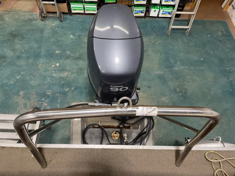 Slide: The Image of 2010 South Bay 520CR with Yamaha 90 outboard motor in a workshop setting. - 25