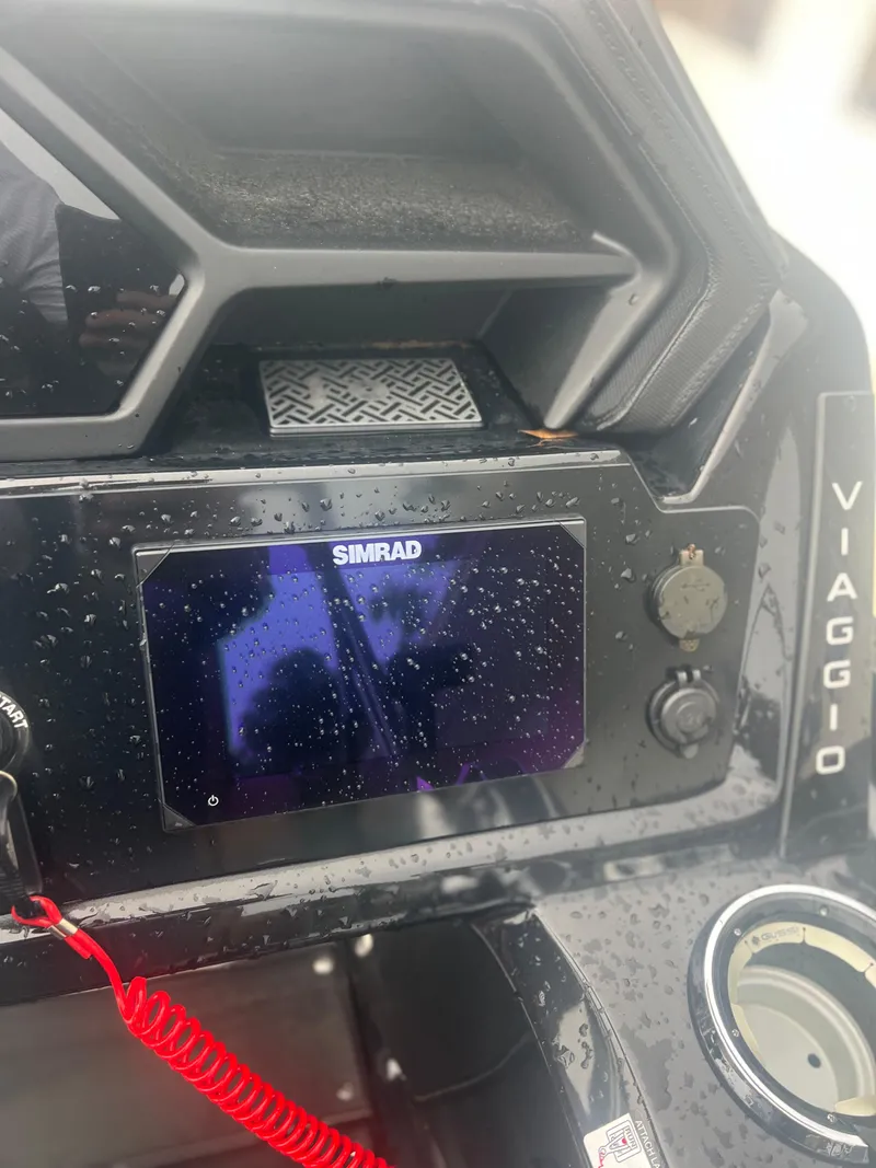 Slide: The Image of Dashboard of a 2024 Viaggio Z24S with Simrad display, wet from rain. - 12
