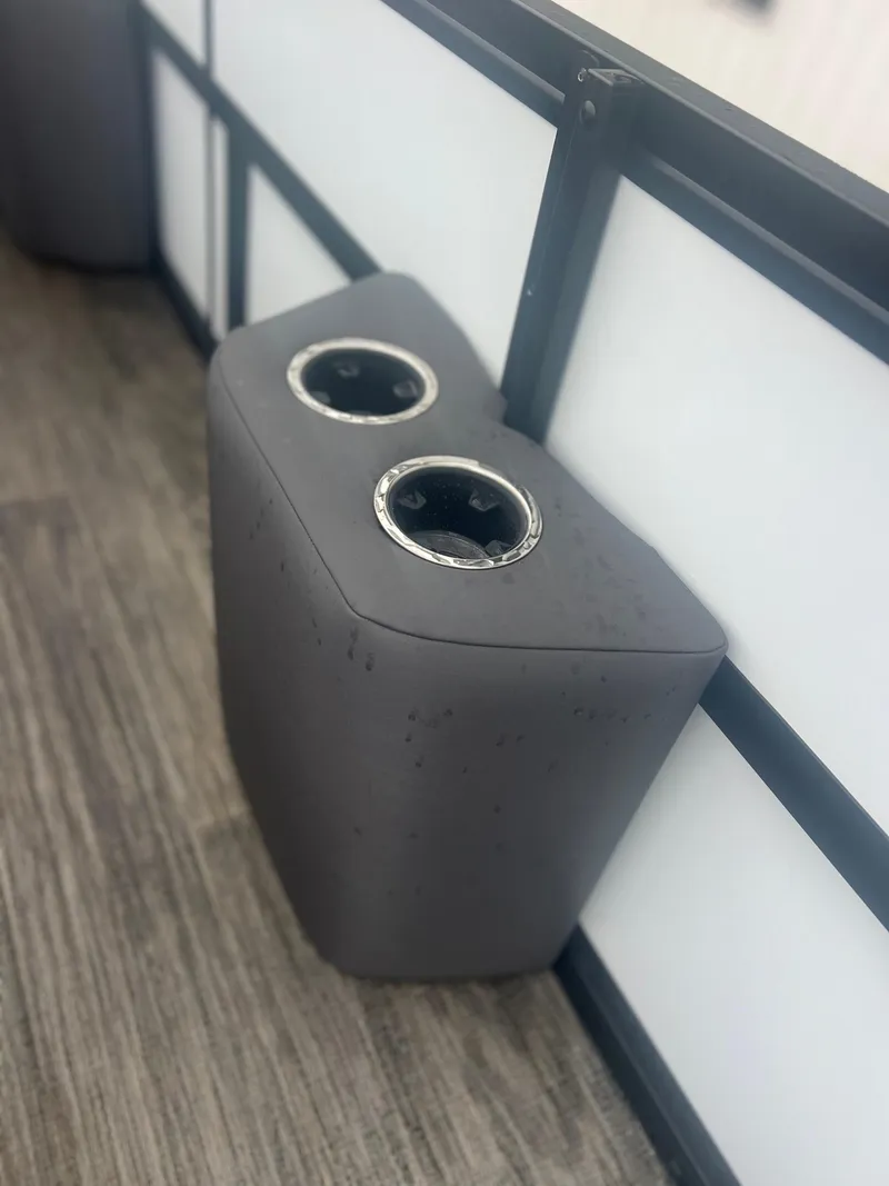 Slide: The Image of Gray dual cup holder in Viaggio Z24S, 2024 model, on wooden floor. - 14