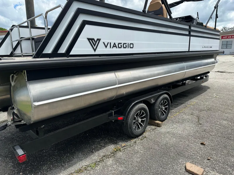 Slide: The Image of 2024 Viaggio Z24S pontoon boat on trailer, side view with logo visible. - 5