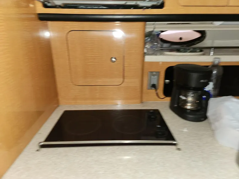 Slide: The Image of 2005 Chaparral Signature 350 kitchen with stovetop and coffee maker. - 11