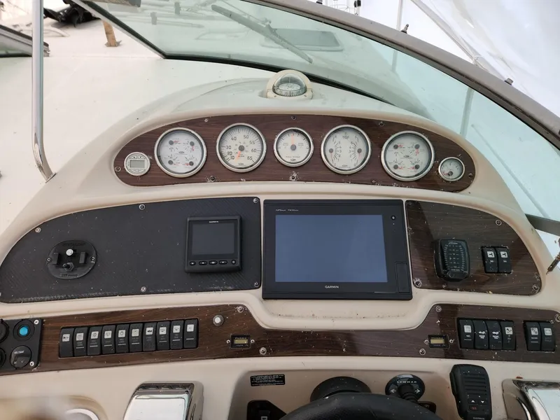 Slide: The Image of Control panel of a 2005 Chaparral Signature 350 boat with gauges and navigation equipment. - 5