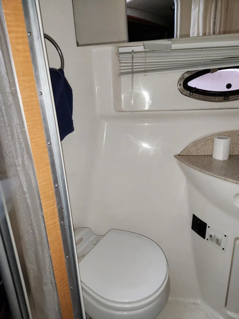 Slide: The Image of 2005 Chaparral Signature 350 bathroom with toilet and porthole window. - 7