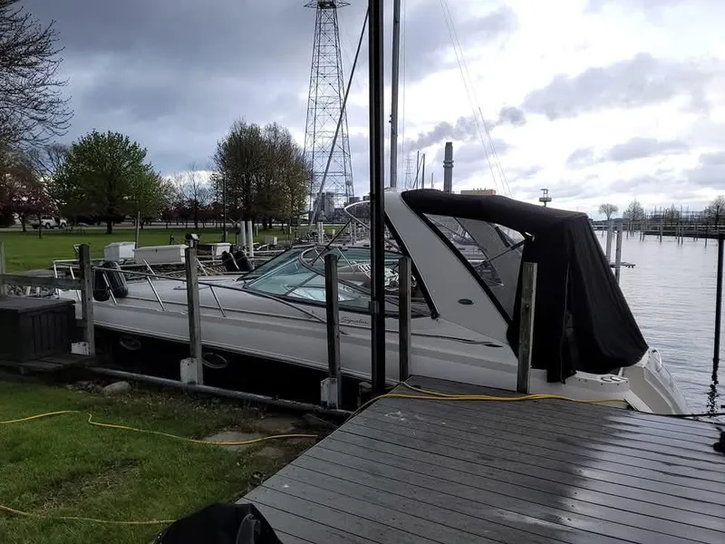 Slide: The Image of 2005 Chaparral Signature 350 boat docked by a lakeside pier under cloudy skies. - 9