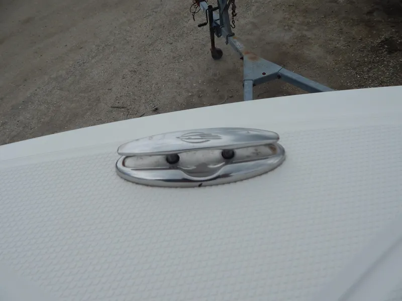 Slide: The Image of 2016 Chaparral 246 SSi boat cleat on textured deck, with trailer in background. - 12
