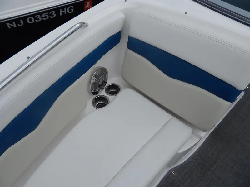 Slide: The Image of 2016 Chaparral 246 SSi boat interior with white and blue seating, cup holders. - 14