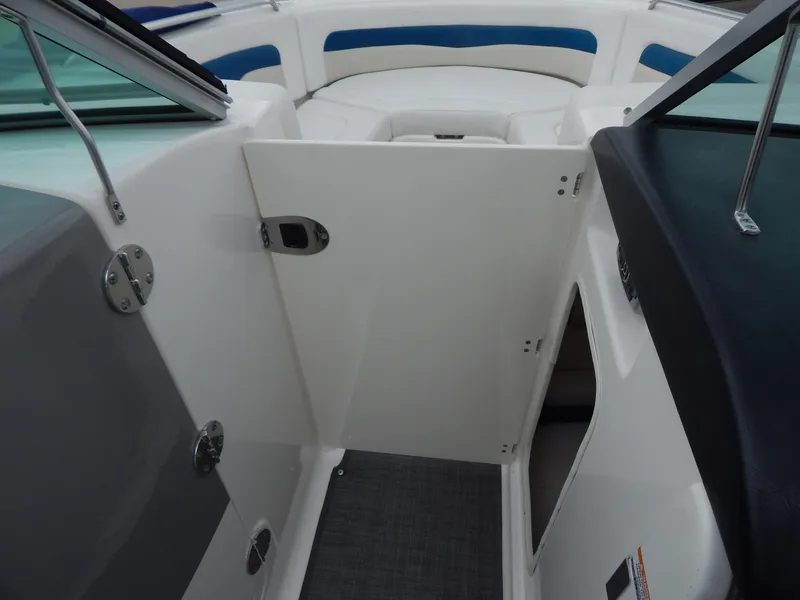 Slide: The Image of 2016 Chaparral 246 SSi boat interior with open door and seating area. - 20